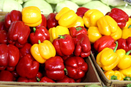bulgarian pepper is ripe juicy sweet red and yellow on the trading table next to white cabbageの写真素材