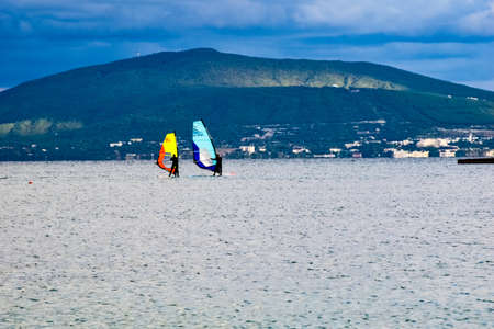 two people on boards under bright sails together catch the wind in the sea bay near Novorossiyskの写真素材