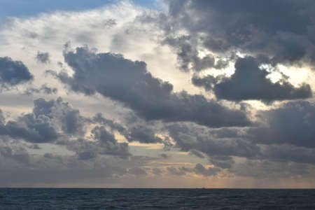 sunlight breaks through the clouds at sunsetの写真素材