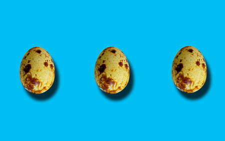 Top view, Set of three brown quail egg standing isolated on cyan for background or stock photo,...