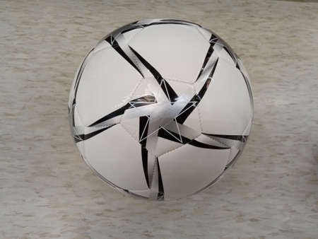 Single rubber soccer ball on white cement floor background for stock photo, match play, alone...