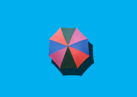 Closeup, Single rainbow umbrella isolated on white background for stock photo or design, invesment, business, summer conceptの写真素材