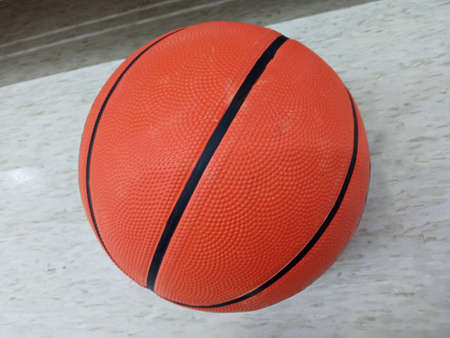 Single new basketball on white cement floor background for stock photo, match play, team, sport equipmentの写真素材