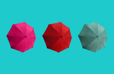 Top view, Set three colours umbrella isolated on cyan background, stock photo, summer concept, red pink dark cyan colorsの写真素材