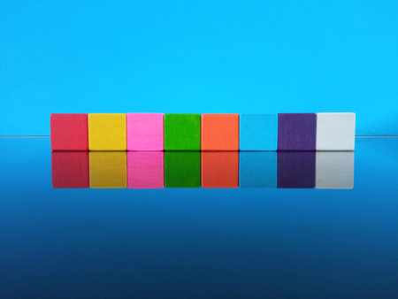 Colorful wooden block toys cids on table blurred cyan background for stock photo. Concept of decision making process, logical thinking. play game board, business financeの写真素材