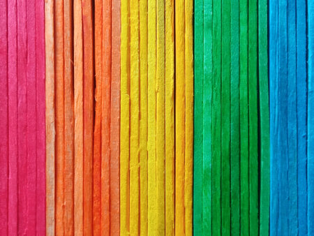 vertical rainbow pattern plank wall background texture for design or stock photo, colourful wooden, pink orange yellow green blue colorsの写真素材
