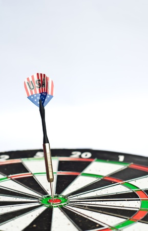 dart in center of dartboard with isolated white backgroundの写真素材