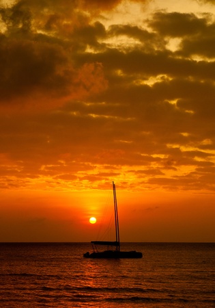sunset with Catamaran boat silhouetteの写真素材