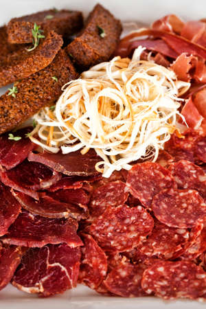 Italian salumi meat platter - prosciutto ham, bresaola, pancetta, salami and suluguniの写真素材