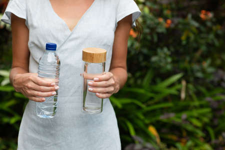 Choosing between plastic bottle and glass bottle. Zero waste concept. Green and conscious lifestyle...