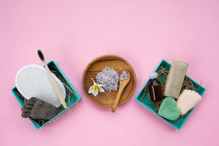 Natural bathroom accessories in two boxes: luffa washcloth, make up remover in a glass container,...