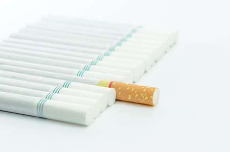 cigarettes with a brown filter macro shot in white backgroundの写真素材