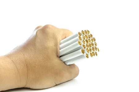 Man\'s hand crushing cigarettes stop smokingの写真素材