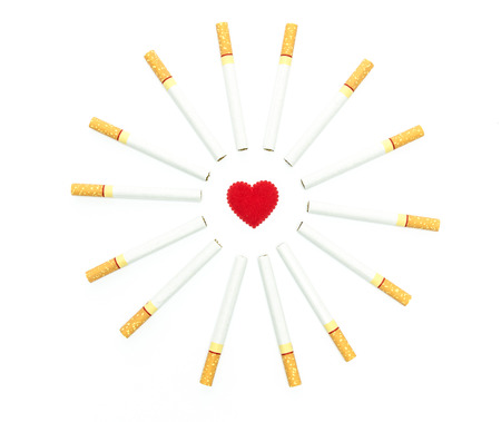 cigarettes around red heart design for ideas and conceptualの写真素材
