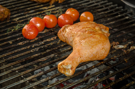 A leg chicken is grilling on grillの写真素材