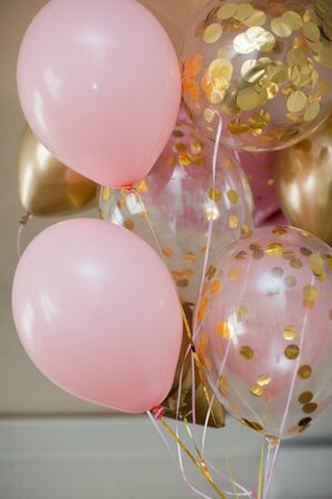 Pink and golden balloons with text "it's a girl" gender reveal party. Gender partyの写真素材
