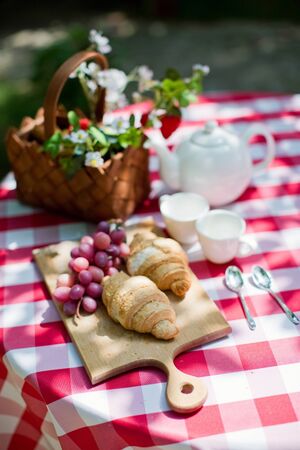 Tasty croissants with grape on the wooden desk. Picnic timeの写真素材