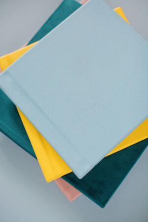 Blue, yellow, green and pink books on a blue background
