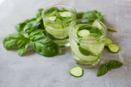 Fresh summer green vegetable cocktail. Mocktail with basil leaves anf cucumber. Green fresh drink on...