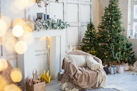 White living room with fireplace, Christmas trees and Christmas decorationsの写真素材