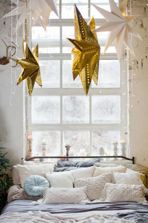 Christmas loft bedroom with big windows, Christmas decorations, Christmas trees and lights. Loft...