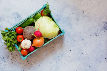 Fresh vegetables in a blue wooden box. Food delivery. Organic eco marketの写真素材