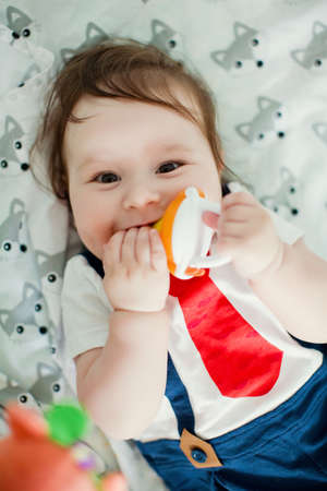 Cute little boy eat fruits from baby's nibbler