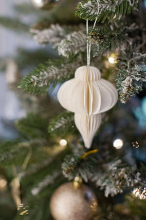 Rustic Christmas tree with handmade decorations. Cozy light interior with Christmas decorations and lightsの写真素材