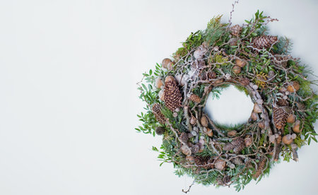 Christmas wreath on a white background. Natural wreath with pine cones, nuts, branches and green...