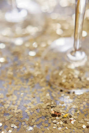 Glass of champagne with golden stars confetti on the silver tray. New year party conceptの写真素材