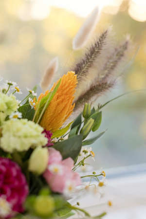 Fall autumn bouquet in pumpkin with bright flowers and ribbonsの写真素材