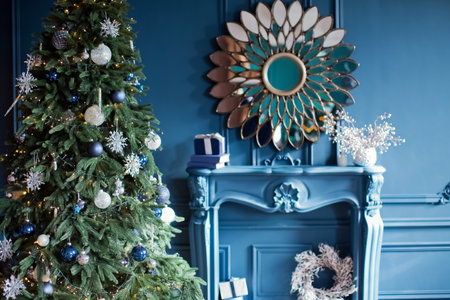 Blue and silver Christmas interior. Living room with blue walls, blue sofa and silver and blue Christmas decorations on Christmas treeの写真素材