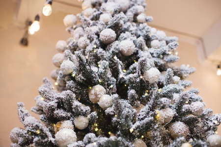 Christmas tree with golden and brown decorations and lights, copy space, place for text