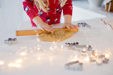 Christmas baking background: dough, cookie cutters and Christmas decorations. Christmas cookies on a...
