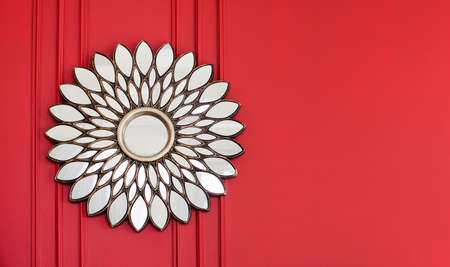 Beautiful vintage silver mirror on a red wall. Interior concept with copy spaceの写真素材