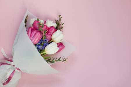 Beautiful spring bouquet on a pink background with copy space, place for text. Spring holiday...