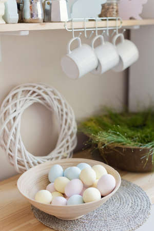 Easter eggs in vintage bowl on a light kitchen interior