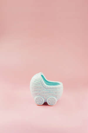 Blue pram decoration. Gender reveal party with pink and blue decorations on a pink background. boy or girl partyの写真素材