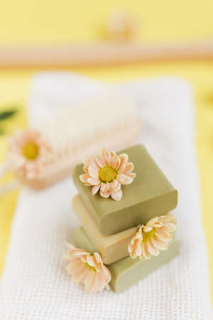 Natural aroma homemade soap with flowers on a white cotton towel. Eco handmade, natural care of body...