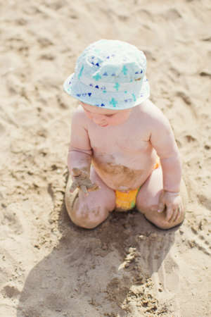 Caucasian baby boy in swimming circle toy swims at poolの写真素材