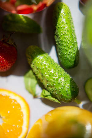 Fresh summer fruit and vegetable cocktails. Cucumber, orange, strawberry and mint backgroundの写真素材