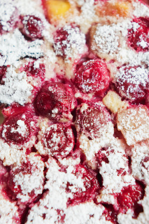 Cherry pie with cream filling, french dessert clafoutis with red sweet cherries, sugar powder....