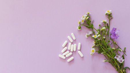 Allegry concept, flowers and pills on a pink background with copy spaceの写真素材