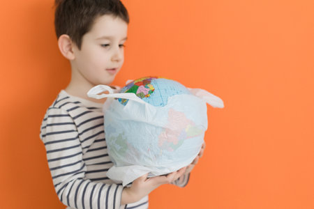 Child holds eco bag with fresh vegetables from farm market on an orange background with copy space. Healthy food concept, fresh vegetables, farm marketの写真素材