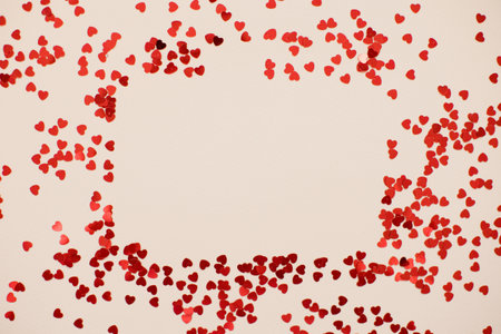 Border frame with heart shaped confetti on a pink background with copy spaceの写真素材