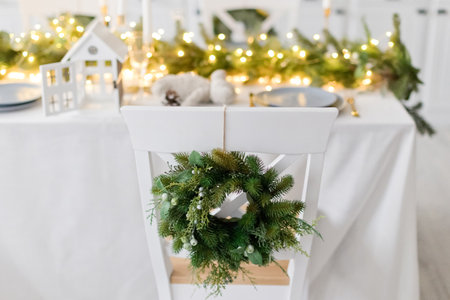 Light kitchen with serving table, Christmas decorations and chair with wreathの写真素材