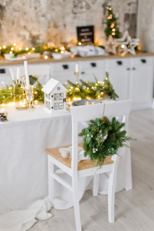 Light kitchen with serving table, Christmas decorations and chair with wreathの写真素材