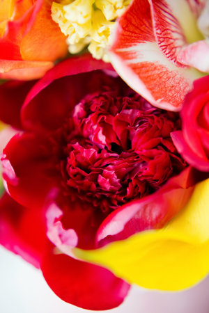 Big pink gift box with bright flowers. Red and yellow flowers, bouquet for Mothers day, Valentines day, birthday party or other holidays. Bouquet with roses, calla lily, amaryllis and peonies.の写真素材