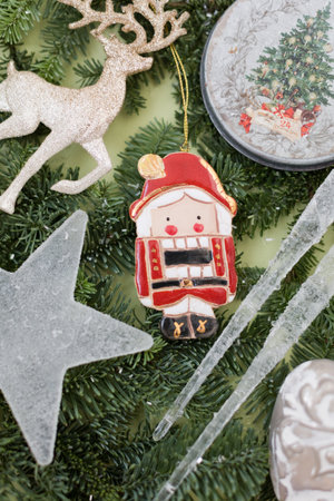 Background with vintage Christmas decorations. Glass star and icicles, glitter reindeer and vintage...