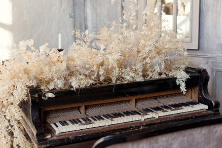 Vintage grand piano with white flowers lunaria and ruscus at light interiorの写真素材